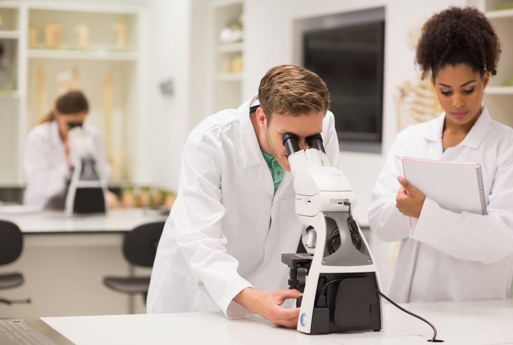 Medical students working with microscope at the university